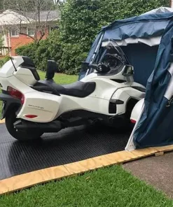 customer image of a deluxe speedway shelter with floor in a backyard open with a 2017 CAN-AM® SPYDER® RT 6-SPEED SEMI-AUTOMATIC inside with extra room