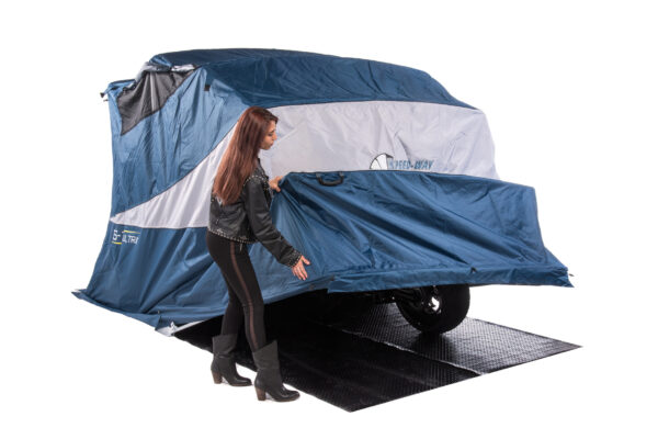 female biker demonstrating how easy to open and close deluxe speedway motorcycle shelter