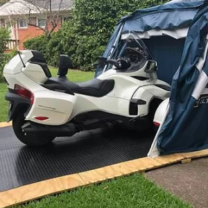can am spyder in deluxe speedway shelter with durable rubber flooring