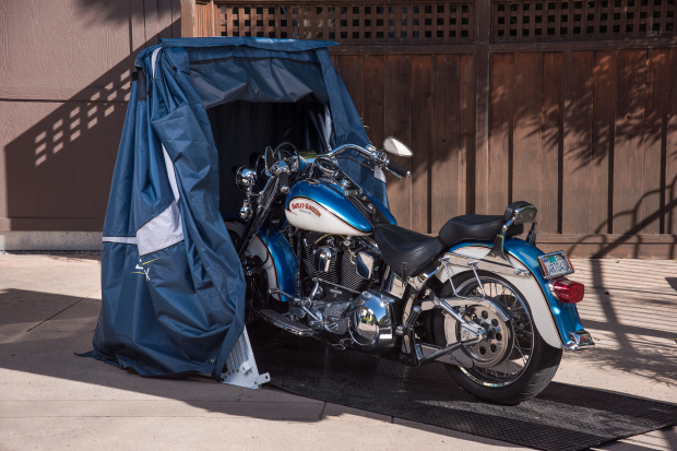blue motorbike inside a sport speedway shelter in a backyard