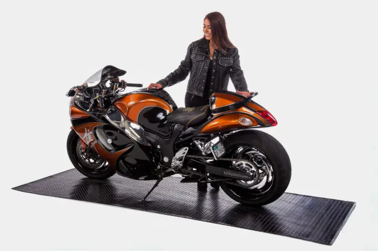 Orange sport bike parked on Speedway high-density rubber motorcycle flooring