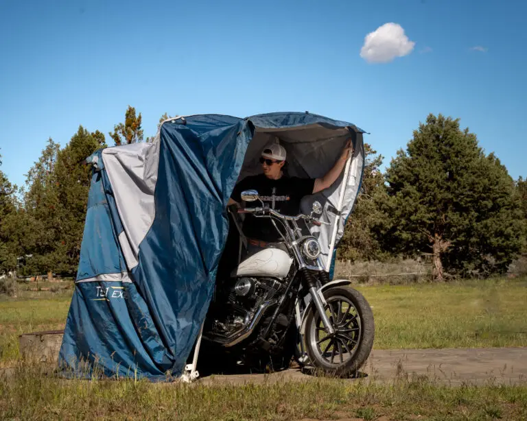 Rider on a motorcycle in an open Speedway Shelter in a field