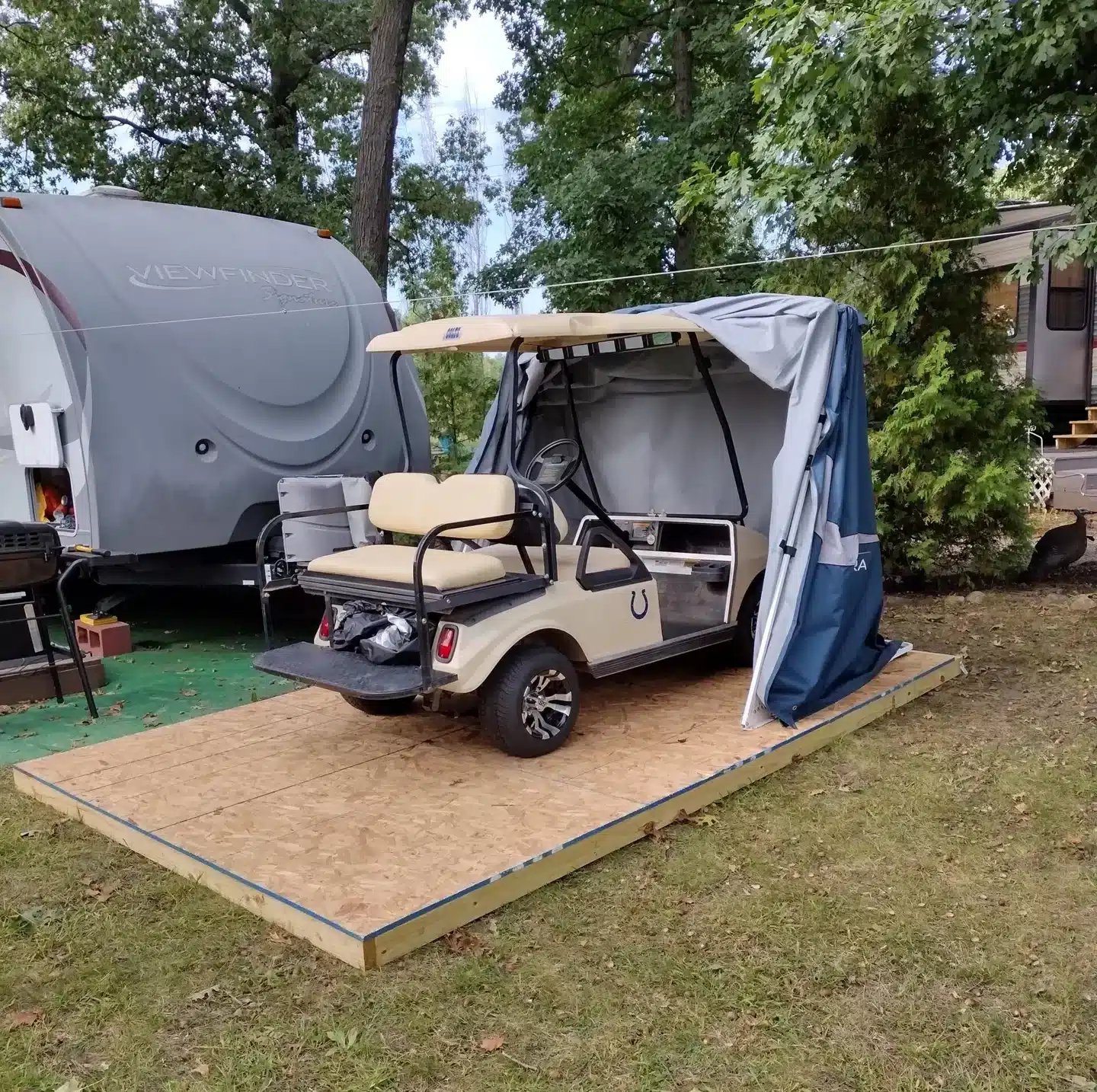 Golf cart parked in a Deluxe Speedway Shelter on a wooden deck
