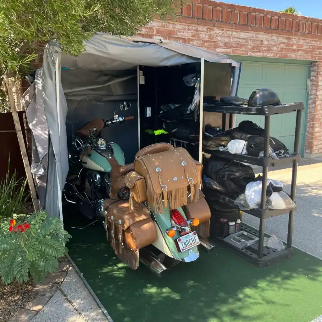 Indian motorcycle and riding gear stored in an open Speedway Shelter