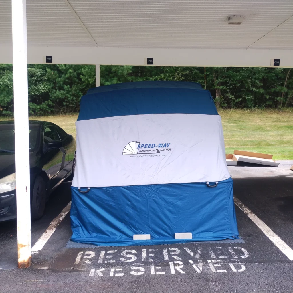 Speedway Shelter set up in a reserved carport parking space