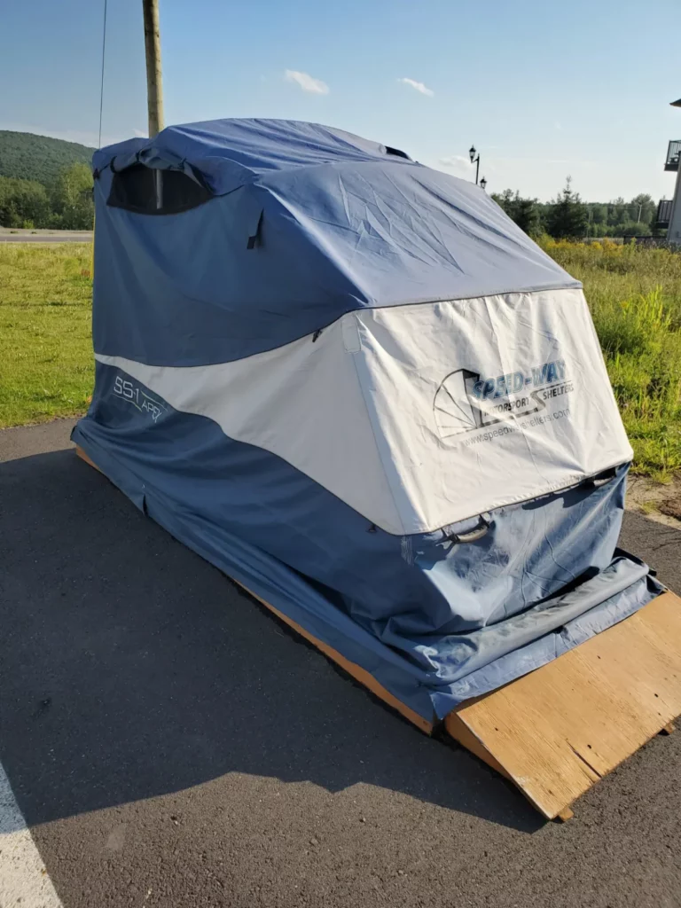Speedway Shelter set up on a wooden base on a driveway