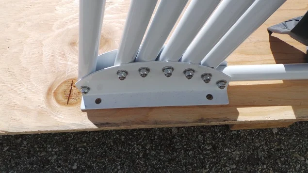 Speedway Shelter frame pivot plate bolted through the plywood wood base