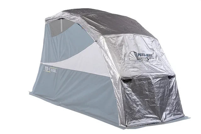 Silver Double Duty UV cover installed on a Touring Speedway Shelter, with the shelter faded so the cover stands out