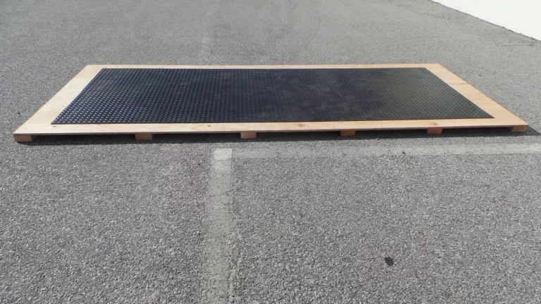 Finished plywood wood base on 2x4s with a Speedway rubber motorcycle shelter floor on top