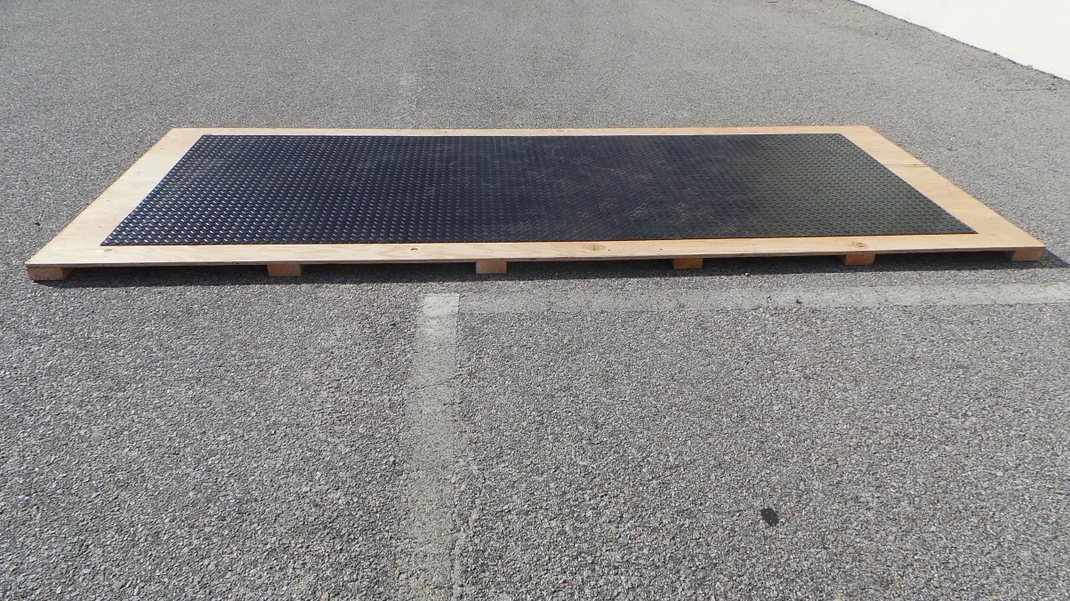 Finished plywood wood base on 2x4s with a Speedway rubber motorcycle shelter floor on top